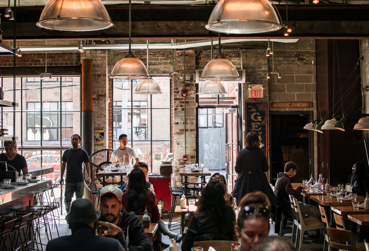 The restaurant salon in warm light with tables occupied